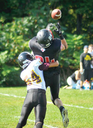 Perfect timing shown by number 54, Tristan Petawabano, to prevent a Titan pass 
completion. Photo: Dave McColl